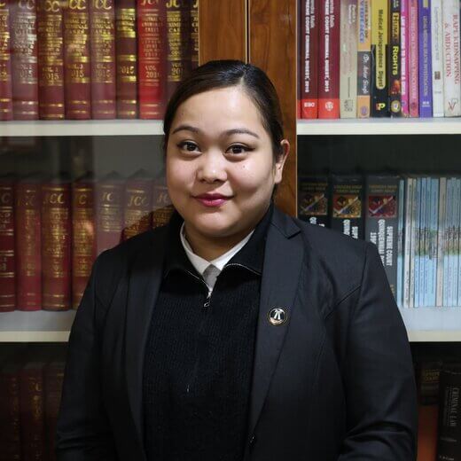 Advocate Preetika Samant in lawyer dress standing in office