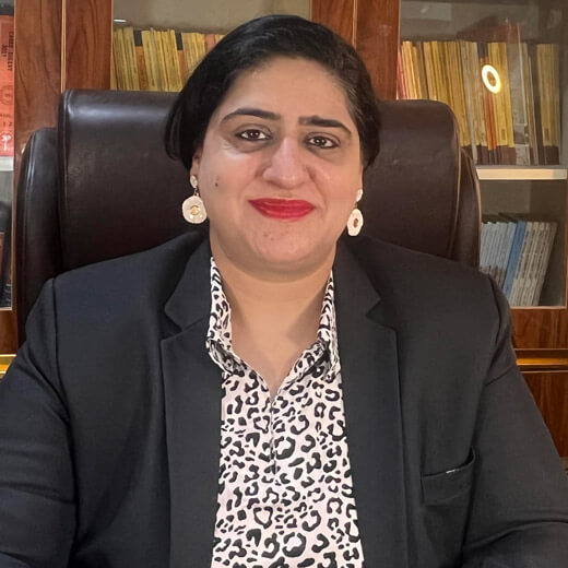 Advocate Nandita S. Chowdhry in legal attire at office desk