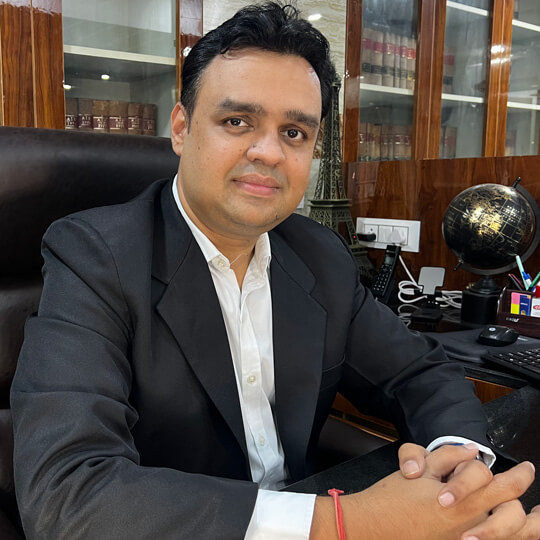 Advocate Sarang S. Chowdhry in lawyer attire seated at his office desk